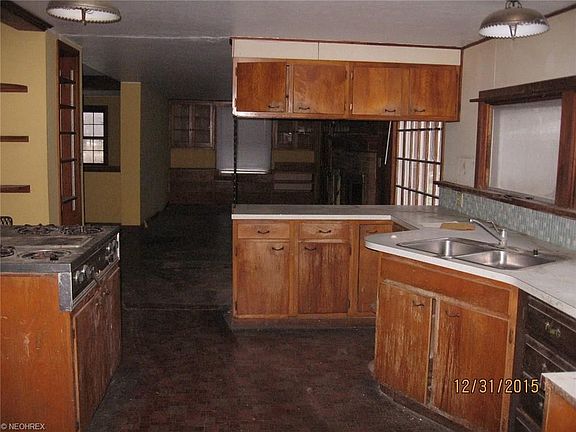 Main house kitchen is open to eat in area with fireplace and built ins.