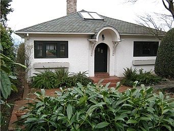Front of the home facing 17th Street with private front yard and large brick patio.