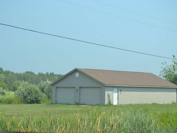 The cart shed is off to the East of the lot.  It measures 30x50  and has 2 sets of overhead doors and one access side door.  The inside is open with no barriers.  