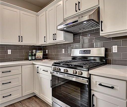 Quartz countertops throughout the kitchen and bathrooms.