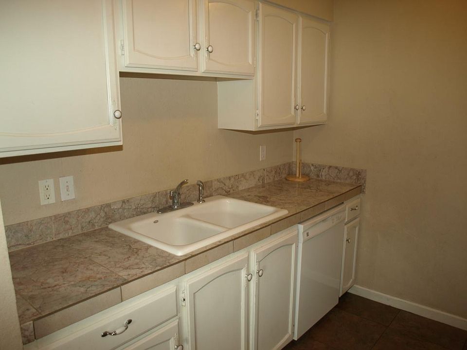 Kitchen with tiled counters and floors