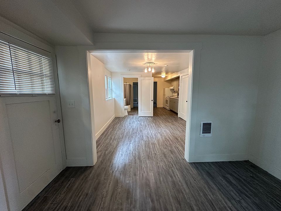 living room with view of the front door, looking into the dining area / kitchen / bathroom access