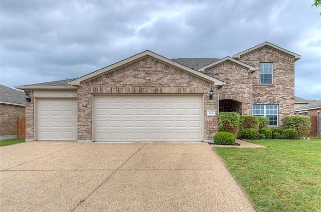 Gorgeous brick and a 3-car garage give the front of this home an inviting feel.