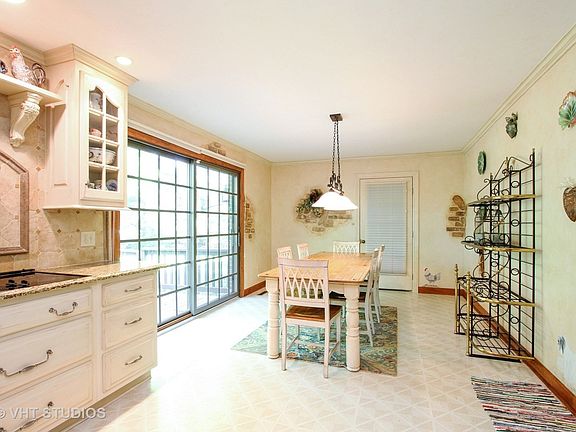 Nice large eat in area adjacent to the kitchen, with sliding doors to the back deck.  It accommodates a large table.  There's another door that leads right into the shed.