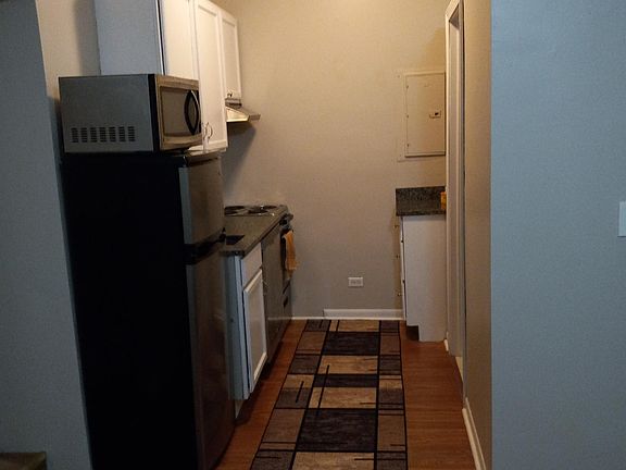 Kitchenette, with range, dishwasher, frig, micro, plenty cabinets. wood flooring.