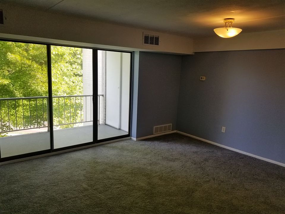 Covered Balcony overlooking greenery and Living Room