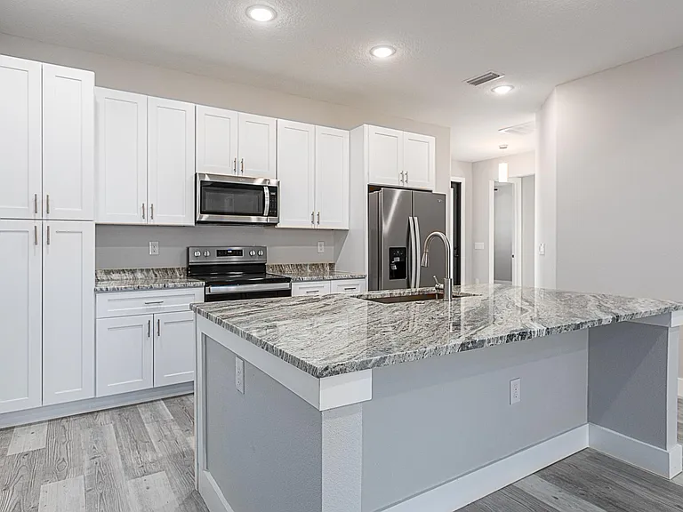 Nice tuck in space under island for seating. Convenient electrical outlets placed around island.