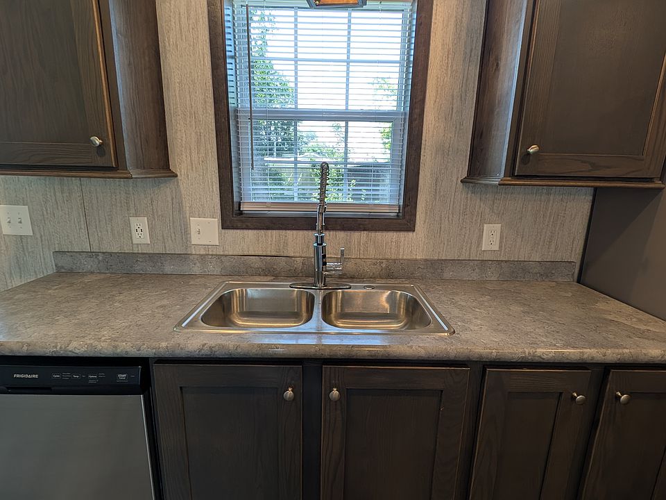Double sink with window above and dishwasher to left.