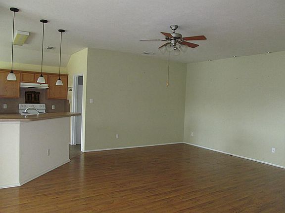 Living area with ceiling fan will hold any size flat screen.