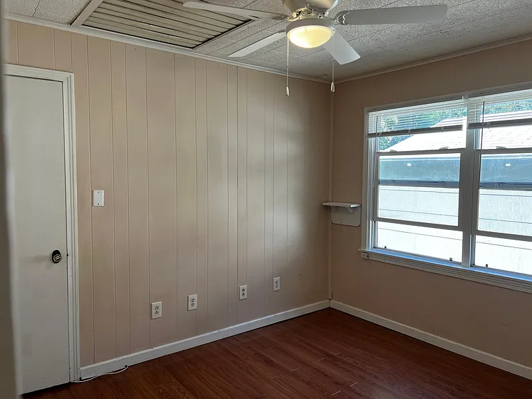 Bedroom number three, with ceiling fan and newer windows and closet.