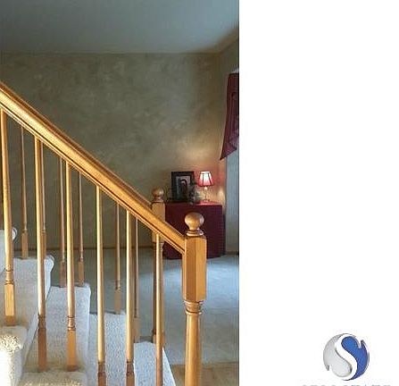 Enter the home with a beautiful wood stair case. Entry has wood floors with the living room to the right and a powder room to the left.