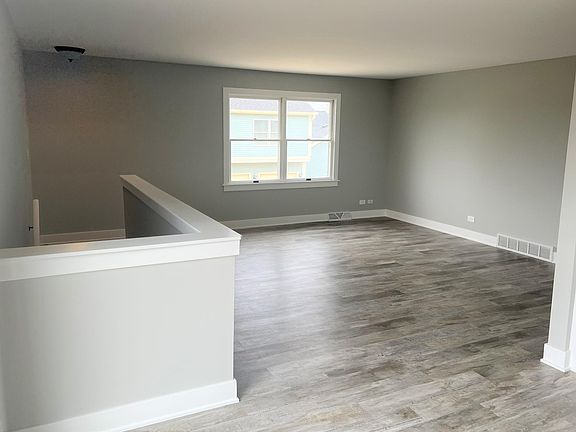 Living room standing at sliding glass door to deck.