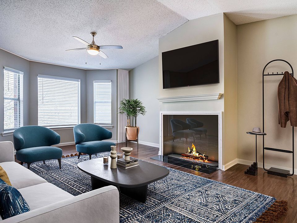Living area's large windows and fireplace