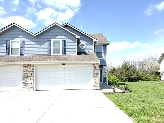 Front of house #2. Two car garage. Driveway.