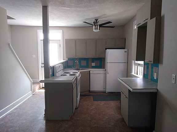 Open area 1st floor plan - Kitchen new stove, counter tops, sink, faucet. Refrigerator and dishwasher one year old. Back door to patio and small yard!