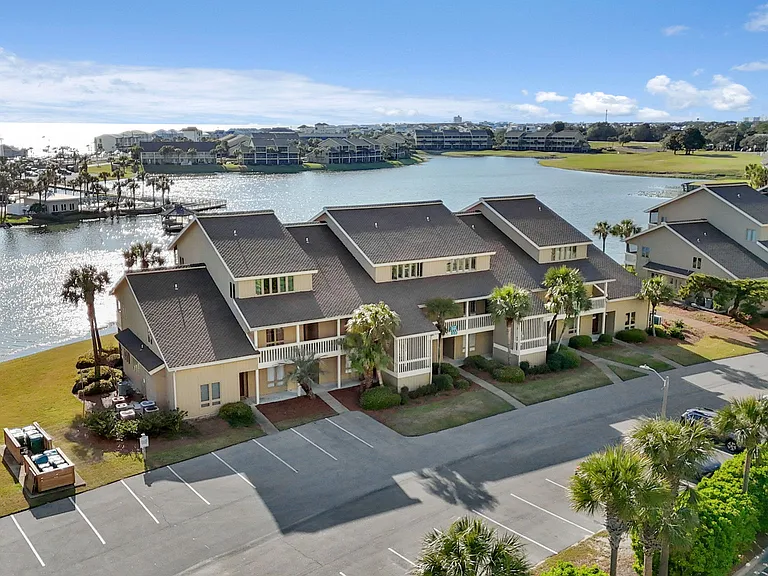 Two parking spaces are allotted for guests. The front of the villa aerial view. Condo is the middle unit.