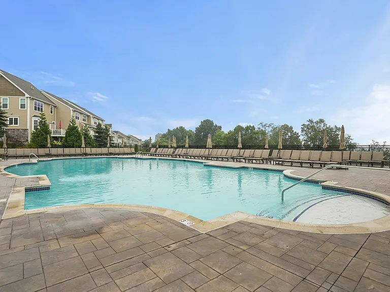 The second clubhouse pool offers a stunning scenic backdrop and a private pool cabana_the perfect spot for summer relaxation.