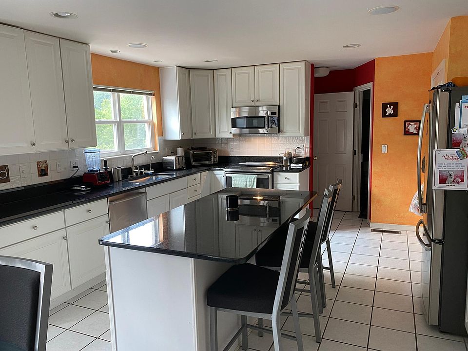 24x14.5 Kitchen with 3'x6' kitchen island, GE Profile microwave, refrigerator and induction cook-top/range, Bosch dishwasher and large deep sink.