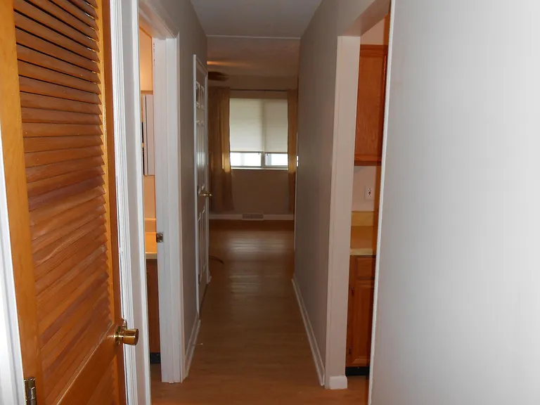 hallway outside bathroom leading to the living room