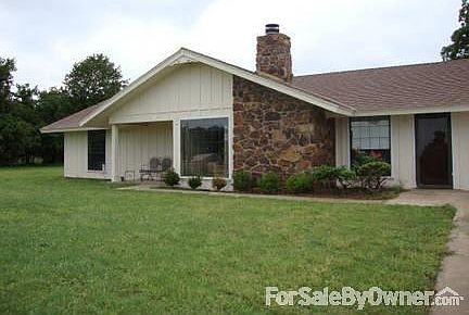 Front of house
						:
						Shrubs have been removed and flowers planted.