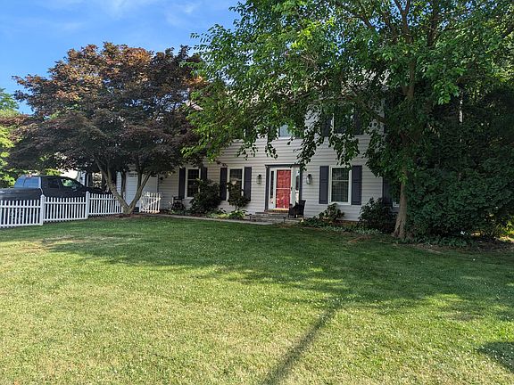 The property is 1/3 acre and features a large, flat, fenced yard and mature trees