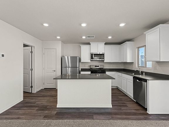 The beautiful kitchen of the Cypress has sprawling granite countertops.