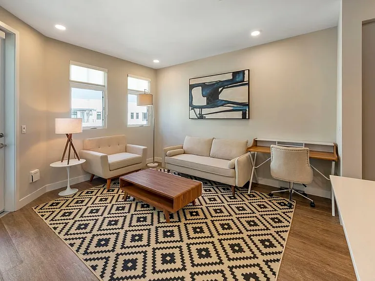 Furnished+ apartment homes come outfitted with a sofa, side chair, side table, coffee table, TV stand and 50" Television (Representative Image exact items and style of furnishings may vary)