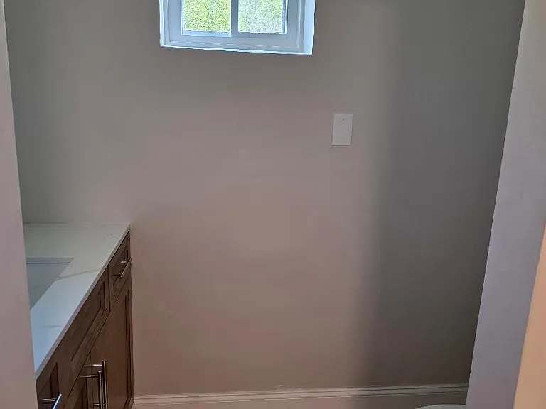 View of partial sink and comode area in 1st. floor bathroom