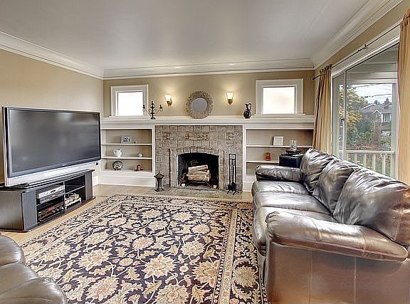 Living Room.  Original fireplace tiling, gleaming oak hardwoods