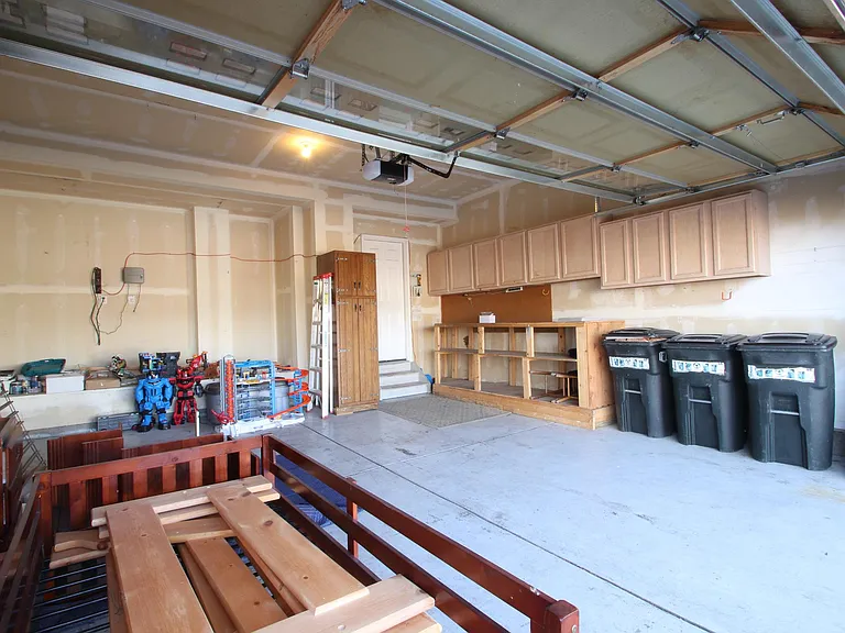 Deep garage with custom cabinets for all your storage needs!