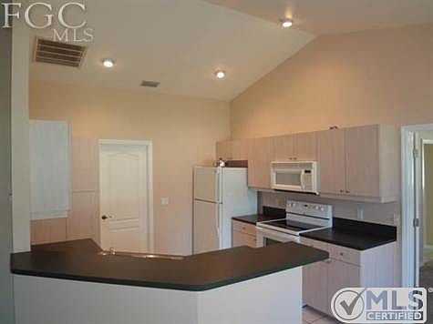 Vaulted fully equipped open kitchen.