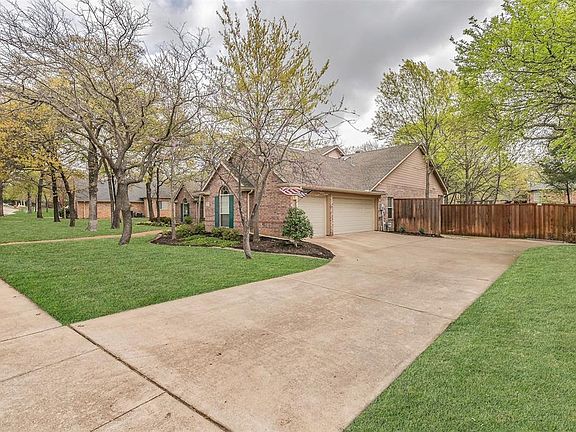 Long driveway leading to side entry oversized 3 car garage with openers and exterior keypad access.