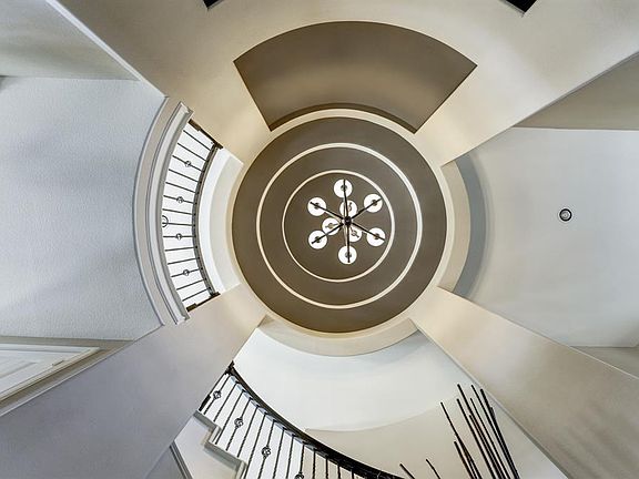 Looking up to the circular rotunda with tray ceiling and designer paint to make it even stand out more.