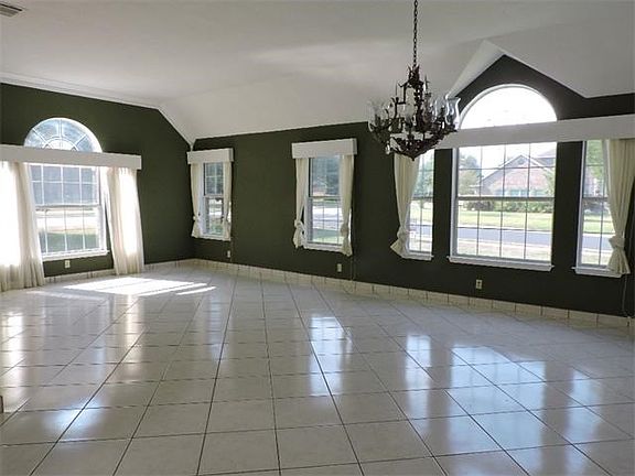 10 ft. high ceilings and crown molding with elegant chandelier
