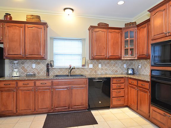 Updates to kitchen includes Newer Cook-top, Dishwasher, Trash Compactor, Granite Sink and Granite Counter Tops