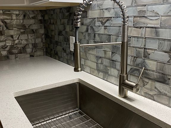 Beautiful backsplash with modern kitchen sink.