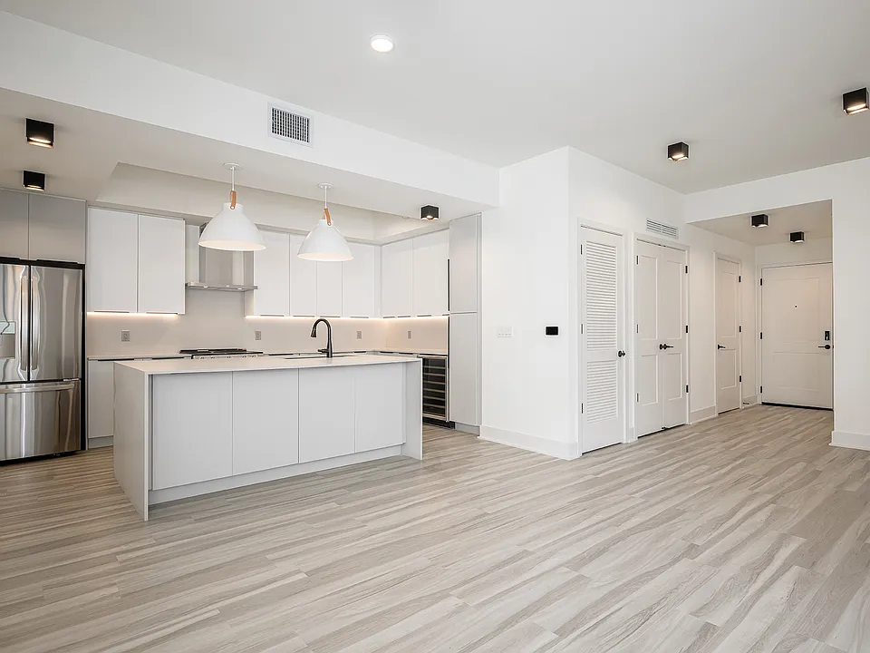 Spacious living area with hardwood-inspired flooring throughout