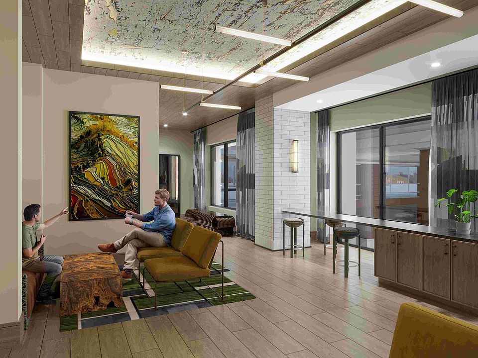 A flexible business lounge offering collaborative seating, vibrant artwork, and a polished environment for work or study.
