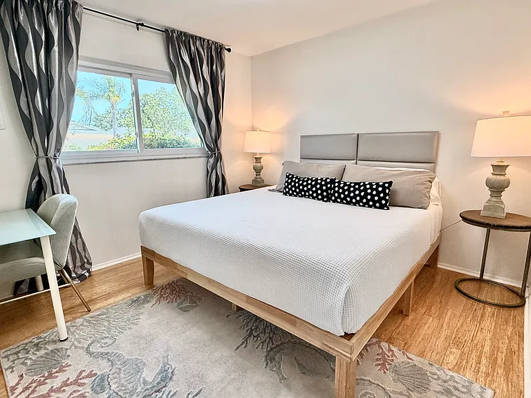 King bed with memory foam mattress, blackout curtains.