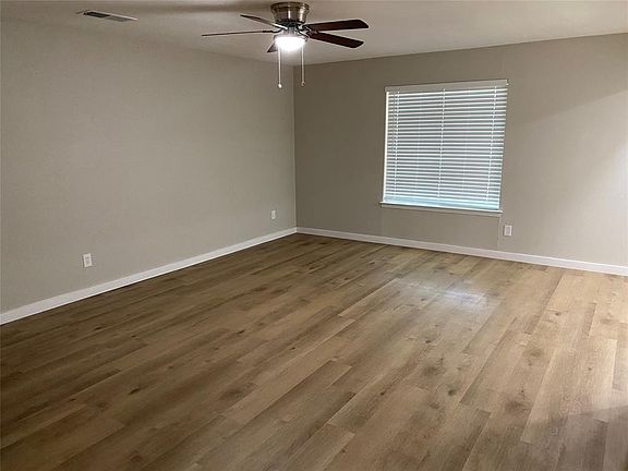 Living room with new flooring, paint and light fixtures