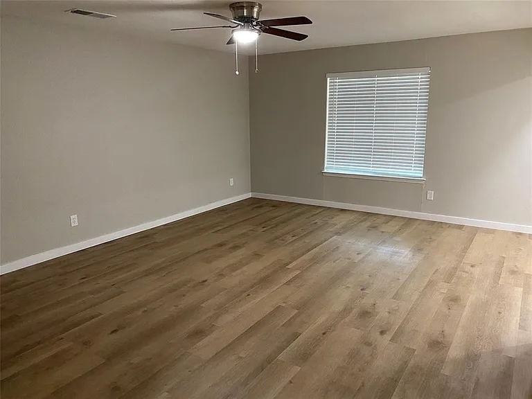 Living room with new flooring, paint and light fixtures