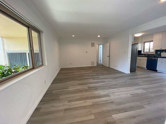 Extra spacious ocean and garden view living room with open floor plan to the dining area and gourmet kitchen and out to backyard