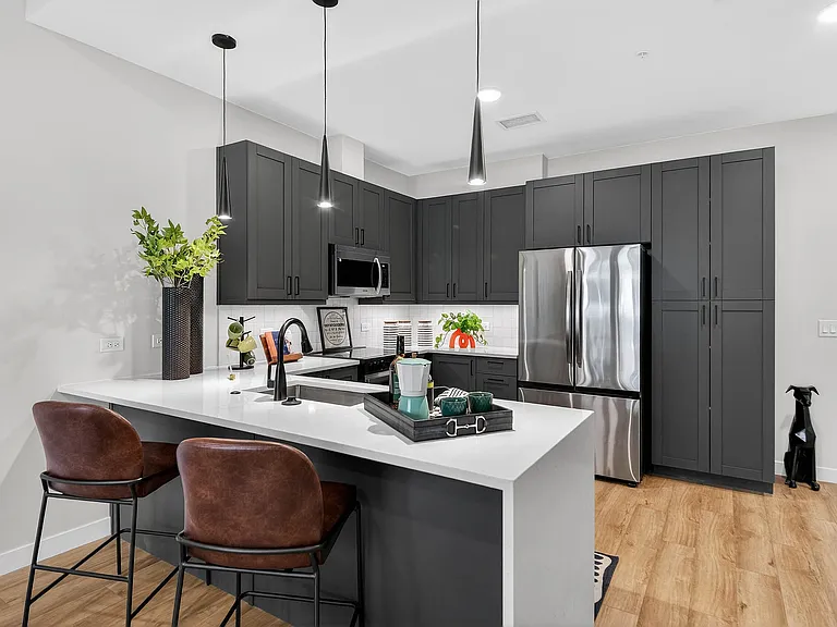 Modern kitchen and living space with wood-style flooring