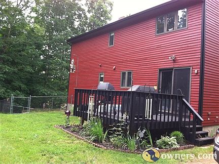 Back view with pet fence and deck