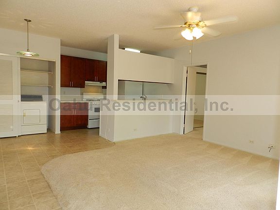 Front door toward kitchen and laundry with full-size applian