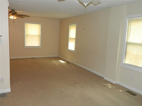 "L" SHAPED LIVING ROOM DINING ROOM BOTH HAVE CEILING FANS