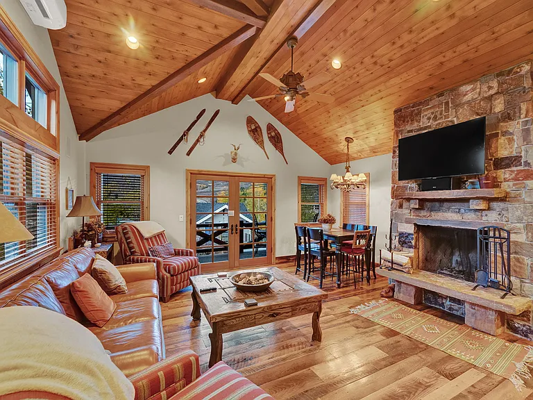 Open living room with wood burning fireplace.