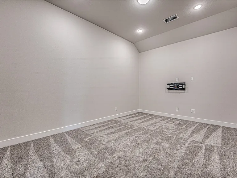 Versatile bonus room featuring recessed lighting, a ceiling vent, and a pre-installed television mount