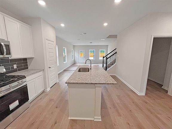 The Waring III- Kitchen into Family Room. Home under construction. Sample floor plan photo used for
