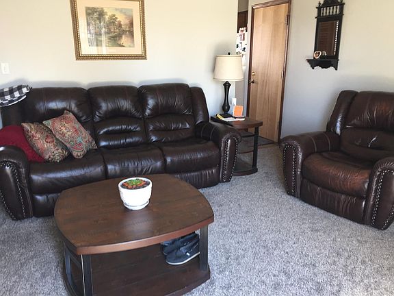 Family room has high ceiling giving it great feeling of space and light from patio door to expansive back yard.